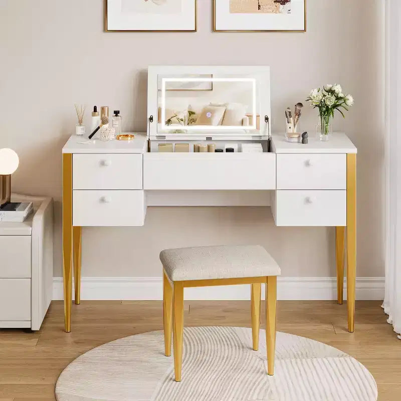 Une coiffeuse avec lumières et tabouret